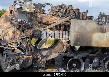 Burnt-out combine harvester, Steinbergkirche, Schleswig-Holstein, Germany Stock Photo