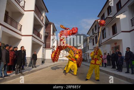 (190221) -- BEIJING, Feb. 21, 2019 (Xinhua) -- People perform dragon dance at Baishui relocation site in Shadaogou Town of Xuan en County in Enshi Tujia and Miao Autonomous Prefecture, central China s Hubei Province, Jan. 17, 2019. China has made important and decisive achievements in poverty relief in the past six years, and will continue its efforts this year to lay a solid foundation for winning the battle against poverty by 2020, an official said Wednesday. In the past six years, China lifted 82.39 million rural poor out of poverty, with the rural poor population down from 98.99 million at Stock Photo