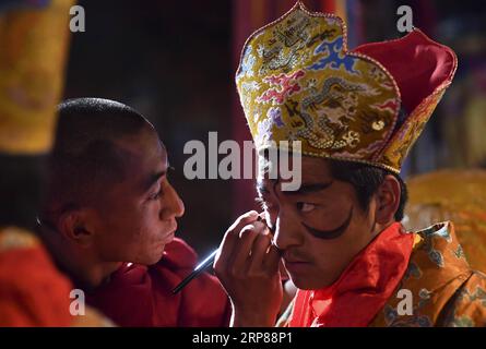 (190222) -- BEIJING, Feb. 22, 2019 -- A Tibetan Buddhist monk gets make-up before a Cham dance ritual at the Qoide Monastery in Gonggar County of Shannan Prefecture, southwest China s Tibet Autonomous Region, Feb. 19, 2019. Dressed in colorful costumes, the lamas will dance to pounding drums at the Qoide Monastery during the Tibetan New Year celebrations. ) XINHUA PHOTOS OF THE DAY PurbuxZhaxi PUBLICATIONxNOTxINxCHN Stock Photo