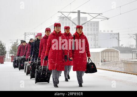 (190223) -- BEIJING, Feb. 23, 2019 (Xinhua) -- Train attendants walk towards the platform at Taiyuan South Railway Station in Taiyuan, north China s Shanxi Province, Feb. 14, 2019. China has banned gender discrimination practices in recruitment to boost career opportunities for women. No requirements for gender should be included in any recruitment plans or interviews, according to a document released by the Ministry of Human Resources and Social Security and other eight government agencies. It is also forbidden to ask about the marital or fertility status of women candidates during interviews Stock Photo