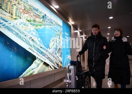 (190225) -- TIANJIN, Feb. 25, 2019 (Xinhua) -- Zhang Shiyu (R) and Lyu Xin walk out of Tianjin Railway Station in north China s Tianjin, Feb. 1, 2019. Zhang Shiyu and Lyu Xin got married in 2018. Although the couple work in Beijing, they chose to buy their wedding house in the neighboring Tianjin City,where Zhang Shiyu was born, given the convenience brought by the Beijing-Tianjin-Hebei integration. They now go to Tianjin every two weeks and return to Beijing on Sunday nights. Thanks to the development of Beijing, Tianjin and Hebei Province -- a regional city cluster called Jing-jin-ji , the y Stock Photo