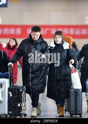 (190225) -- TIANJIN, Feb. 25, 2019 (Xinhua) -- Zhang Shiyu (R) and Lyu Xin walk out of Tianjin Railway Station in north China s Tianjin, Feb. 1, 2019. Zhang Shiyu and Lyu Xin got married in 2018. Although the couple work in Beijing, they chose to buy their wedding house in the neighboring Tianjin City,where Zhang Shiyu was born, given the convenience brought by the Beijing-Tianjin-Hebei integration. They now go to Tianjin every two weeks and return to Beijing on Sunday nights. Thanks to the development of Beijing, Tianjin and Hebei Province -- a regional city cluster called Jing-jin-ji , the y Stock Photo