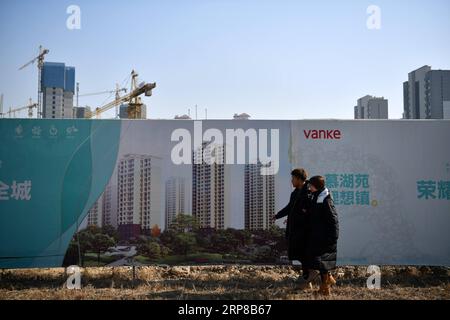 (190225) -- TIANJIN, Feb. 25, 2019 (Xinhua) -- Zhang Shiyu (R) and Lyu Xin watch their wedding house under construction in north China s Tianjin, Feb. 1, 2019. Zhang Shiyu and Lyu Xin got married in 2018. Although the couple work in Beijing, they chose to buy their wedding house in the neighboring Tianjin City,where Zhang Shiyu was born, given the convenience brought by the Beijing-Tianjin-Hebei integration. They now go to Tianjin every two weeks and return to Beijing on Sunday nights. Thanks to the development of Beijing, Tianjin and Hebei Province -- a regional city cluster called Jing-jin-j Stock Photo