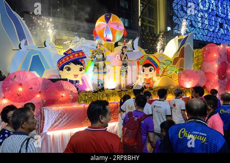 (190226) -- JOHOR BAHRU, Feb. 26, 2019 (Xinhua) -- People watch the flashy floats during the Chingay Night Parade in Johor Bahru, Malaysia, Feb. 25, 2019. Local Chinese in Johor Bahru hold the annual tradition to celebrate the Chinese new year and wish for peace and prosperity with the highlight of the Chingay Night Parade, as deities are carried around the main streets of Johor Bahru joined by procession including floats, lion and dragon dancers. (Xinhua/Chong Voon Chung) MALAYSIA-JOHOR BAHRU-CHINGAY NIGHT PARADE PUBLICATIONxNOTxINxCHN Stock Photo