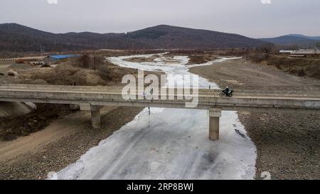 (190226) -- CHANGCHUN, Feb. 26, 2019 (Xinhua) -- Postman Jin Renzhe is on the way to deliver postal packages in Chunhua Township of Huichun City, northeast China s Jilin Province, Feb. 19, 2019. Jin Renzhe has been working as a postman for 30 years in Chunhua Township, where postal service is inadequate because of steep mountain paths and loosely-scattered villages. Despite that, Jin manages to deliver mails to villagers the same day mails arrive in the town. As many young people work outside the town, Jin bridges them and their parents through delivering packages. Living with eye disease and Stock Photo