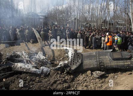 (190227) -- SRINAGAR, Feb. 27, 2019 -- People and Indian army gather near the wreckage of an Indian aircraft after it crashed at village Garend Kalan of Budgam, about 34 km south of Srinagar city, the summer capital of Indian-controlled Kashmir, Feb. 27, 2019. A pilot and a co-pilot of Indian Air Force (IAF) were killed after a Mi-17 jet crashed Wednesday in Indian-controlled Kashmir, Indian officials said. Meanwhile, Pakistan army said on Wednesday the Pakistan Air Force has shot down two Indian fighter jets inside Pakistani airspace and ground troops arrested one pilot of the destroyed jet, Stock Photo
