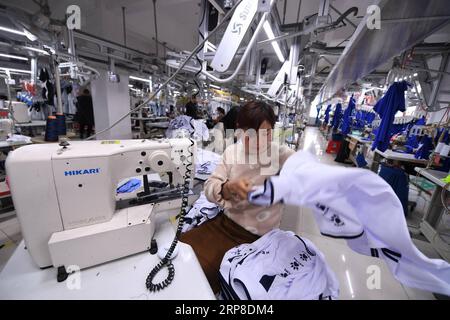 (190301) -- QUANZHOU, March 1, 2019 (Xinhua) -- Wu Huiqing works on the production line in Kelme s factory in Jinjiang of Quanzhou City, southeast China s Fujian Province, Feb. 26, 2019. The Spanish sports brand Kelme, now held by the Chinese clothing company Yuanxiang, has recently got popular among Chinese soccer fans. The craze comes as Chinese soccer player Wu Lei was recently recruited by the Spanish Liga Santander club Espanyol, whose official kit sponsor is none other than Kelme. Within just one month, more than 10,000 Wu Lei jerseys were sold in China, bringing along the sales of other Stock Photo