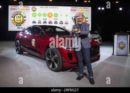 (190304) -- GENEVA, March 4, 2019 (Xinhua) -- Ian Callum, Design Director for Jaguar, poses for photos in front of a Jaguar I-PACE at the Palexpo in Geneva, Switzerland, on March 4, 2019. Jaguar s first electric SUV I-PACE won the Car of the Year award on Monday in a neck-to-neck race against Alpine A110 on the eve of the 89th Geneva International Motor Show (GIMS). (Xinhua/Xu Jinquan) SWITZERLAND-GENEVA-JAGUAR I-PACE-CAR OF THE YEAR PUBLICATIONxNOTxINxCHN Stock Photo
