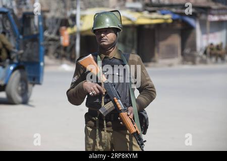 (190310) -- SRINAGAR, March 10, 2019 (Xinhua) -- An Indian paramilitary soldier stands guard during a security lockdown in downtown area of Srinagar, the summer capital of Indian-controlled Kashmir, March 10, 2019. Authorities on Sunday imposed restrictions in parts of Srinagar city to prevent protests after India s anti-terror agency, National Investigation Agency (NIA), summoned key separatist leader and chief cleric of Indian-controlled Kashmir for questioning in an alleged funding case, officials said on Saturday. Mirwaiz Umar Farooq has been asked to appear before the probe agency on Mond Stock Photo