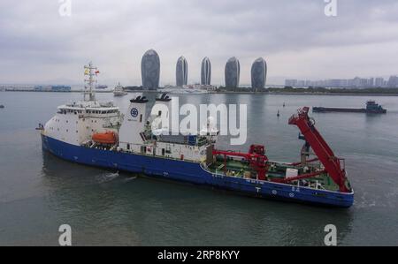 (190310) -- SANYA, March 10, 2019 -- China s science ship Tansuo-1 loaded with the manned submersible Shenhai Yongshi (Deep Sea Warrior) returns to its home harbor in Sanya, south China s Hainan Province, on March 10, 2019, after finishing its first expedition in the Indian Ocean. The 121-day expedition trip organized by the Chinese Academy of Sciences began on Nov. 10, 2018. The ship traveled 17,000 nautical miles on the expedition during which scientists surveyed five deep-sea hydrothermal areas and collected a trove of samples for ecological environment research. ) CHINA-HAINAN-SANYA-MANNED Stock Photo