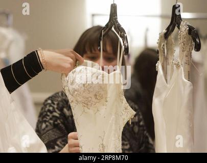 (190311) -- VANCOUVER, March 11, 2019 (Xinhua) -- Women look at wedding dresses during the annual Bridal Swap event in Vancouver, Canada, March 10, 2019. The Bridal Swap is an annual second hand bridal dress recycling event allowing the past brides to sell their used wedding dresses to the brides-to-be who are planning their wedding ceremonies in tight budgets. (Xinhua/Liang Sen) CANADA-VANCOUVER-WEDDING DRESS-RECYCLING EVENT PUBLICATIONxNOTxINxCHN Stock Photo