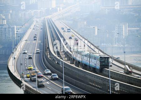 (190317) -- BEIJING, March 17, 2019 (Xinhua) -- Photo taken on March 11, 2019 shows an integrated viaduct for paralleling autos and light rail trains in Chongqing, southwest China. (Xinhua/Wang Quanchao) XINHUA PHOTOS OF THE DAY PUBLICATIONxNOTxINxCHN Stock Photo