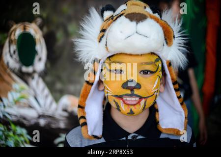 (190317) -- KUALA LUMPUR, March 17, 2019 (Xinhua) -- A boy with a facial painting of tiger poses for photo during the Save Our Malayan Tiger campaign, as part of events to mark the International World Wildlife Day, in Kuala Lumpur, Malaysia, March 17, 2019. Malaysia s government announced the launching of a campaign on Sunday to provide greater protection for the country s tiger amid an alarming increase of poaching. The Malayan tiger, a subspecies of the big cat lives in Southern Thailand and Malaysia, had seen its numbers dwindle to an estimated 250 in the wild in Malaysia due to poaching an Stock Photo