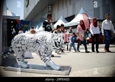 (190317) -- KUALA LUMPUR, March 17, 2019 (Xinhua) -- A statue of tiger is seen during the Save Our Malayan Tiger campaign, as part of events to mark the International World Wildlife Day, in Kuala Lumpur, Malaysia, March 17, 2019. Malaysia s government announced the launching of a campaign on Sunday to provide greater protection for the country s tiger amid an alarming increase of poaching. The Malayan tiger, a subspecies of the big cat lives in Southern Thailand and Malaysia, had seen its numbers dwindle to an estimated 250 in the wild in Malaysia due to poaching and loss of habitat. (Xinhua/C Stock Photo