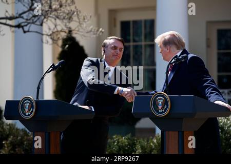 (190321) -- BEIJING, March 21, 2019 (Xinhua) -- U.S. President Donald Trump (R) attends a joint press conference with his Brazilian counterpart Jair Bolsonaro at the Rose Garden of the White House in Washington D.C., the United States, on March 19, 2019. Donald Trump on Tuesday indicated that he may support Brazil to join the North Atlantic Treaty Organization (NATO) and the Organization for Economic Co-operation and Development (OECD), as the two nations expected to further their economic cooperation. (Xinhua/Ting Shen) XINHUA PHOTOS OF THE DAY PUBLICATIONxNOTxINxCHN Stock Photo