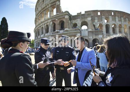 (190321) -- BEIJING, March 21, 2019 (Xinhua) -- In this file photo taken on May 2, 2016, Chinese and Italian police officers check the documents of a Chinese tourist group outside the Colosseum in Rome, Italy. In 2014, China and Italy agreed to launch the joint patrol program during peak travel seasons. Since May 2016, China has sent three groups of police officers to patrol streets in Italy. Italian officers were first invited to the joint patrol in Beijing and Shanghai in April 2017. (Xinhua/Jin Yu) CHINA-ITALY-POLICE-JOINT PATROL PUBLICATIONxNOTxINxCHN Stock Photo