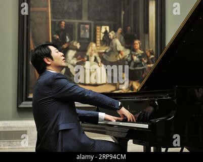 (190322) -- BEIJING, March 22, 2019 (Xinhua) -- Chinese pianist Lang Lang performs at the Museo del Prado as part of the ongoing celebrations for the 200th anniversary of the main Spanish national art museum in central Madrid, Spain, March 21, 2019. Lang Lang performed in the hall dedicated to Diego Velazquez, one of Spain s most famous and loved artists, and in the presence of Velazquez s most famous painting Las Meninas . (Xinhua/Guo Qiuda) XINHUA PHOTOS OF THE DAY PUBLICATIONxNOTxINxCHN Stock Photo