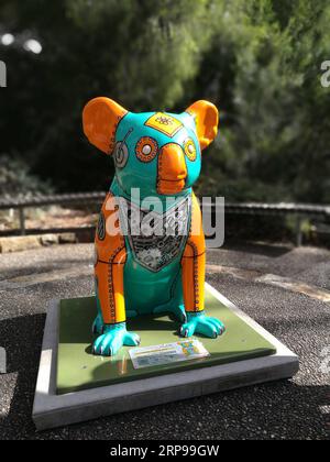 (190329) -- CANBERRA, March 29, 2019 (Xinhua) -- A koala statue is seen at the Australian National Botanic Gardens in Canberra, Australia, March 28, 2019. Fourteen one-meter-tall koala statues decorated by different artists are scattered across the Australian National Botanic Gardens, sitting on the ground for visitors to discover stories behind them on March 1-31. The gardens visitor experience coordinator Megan Donaldson said that the pop-up statues were aimed to raise awareness of Australian plants and native wildlife. (Xinhua/Bai Xu) TO GO WITH Feature: Exploring Australian National Botani Stock Photo