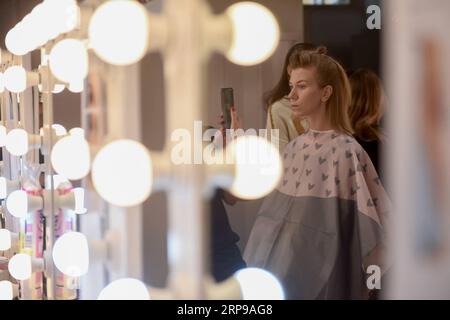 (190331) -- MOSCOW, March 31, 2019 -- A model prepares for the Fashion Week Russia in Moscow, Russia, March 30, 2019. The fashion week would last from March 30 to April 3. Evgeny Sinitsyn) RUSSIA-MOSCOW-FASHION SHOW lujinbo PUBLICATIONxNOTxINxCHN Stock Photo