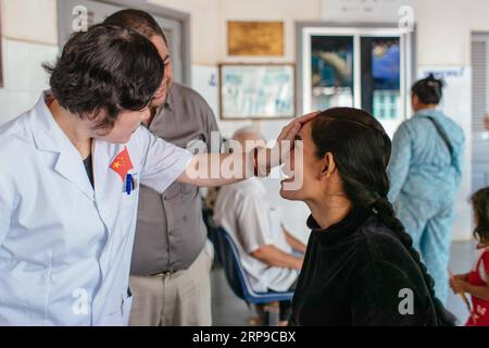 (190402) -- PHNOM PENH, April 2, 2019 (Xinhua) -- Doctor Liang Hao (L) of the First Affiliated Hospital of Guangxi Medical University talks with Sum Meyle after a cataract operation at Kampong Cham Provincial Hospital in Kampong Cham, Cambodia, March 16, 2019. Sum Meyle, 36, is a single mother with five children. To help improve their financial conditions, two of Meyle s daughters are now working in the capital Phnom Penh while two of her sons are living in a children s nursing home. Meyle now lives in a rented shanty house with her youngest daughter. Meyle had suffered from cataract after her Stock Photo