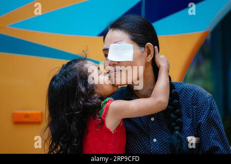 (190402) -- PHNOM PENH, April 2, 2019 (Xinhua) -- Sum Meyle receives a kiss from her daughter before a cataract operation at Kampong Cham Provincial Hospital in Kampong Cham, Cambodia, March 15, 2019. Sum Meyle, 36, is a single mother with five children. To help improve their financial conditions, two of Meyle s daughters are now working in the capital Phnom Penh while two of her sons are living in a children s nursing home. Meyle now lives in a rented shanty house with her youngest daughter. Meyle had suffered from cataract after her left eye was injured. Seven months ago, she had almost lost Stock Photo