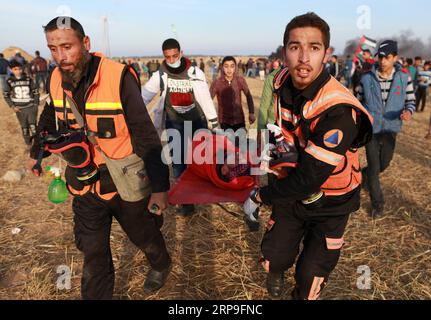 (190405) -- GAZA, April 5, 2019 -- Palestinian medics carry a wounded man during clashes with Israeli troops on the Gaza-Israel border, east of southern Gaza Strip City of Khan Younis, April 5, 2019. At least 83 people were injured on Friday during clashes that broke out between Palestinian demonstrators and Israeli soldiers near the fence of the border between eastern Gaza Strip and Israel, medics said. ) MIDEAST-GAZA-CLASHES YasserxQudih PUBLICATIONxNOTxINxCHN Stock Photo