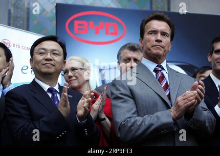 (190405) -- NEW YORK, April 5, 2019 -- File photo taken on April 30, 2010 shows Chinese automaker BYD Chairman Wang Chuanfu (L, front) and then California Governor Arnold Schwarzenegger (R, front) during a press conference at Los Angeles City Hall to announce that BYD will locate its North American headquarters in Los Angeles, the United States. China s leading electric vehicle maker BYD held a ceremony on April 3 to celebrate its 300th bus at its Lancaster manufacturing plant in the U.S. state of California, marking a milestone for production. The 300th bus, a 35-foot BYD K9S model transit bu Stock Photo