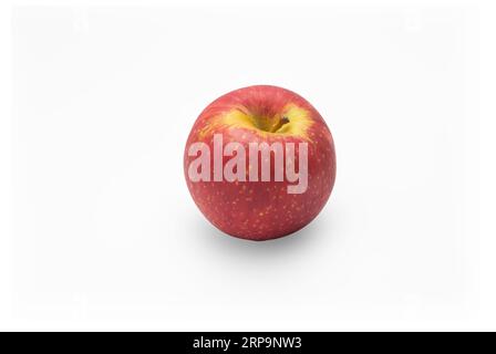 Single perfect fresh organic Ambrosia apple with water drop and leaf on white isolated background, clipping path. red apple is antioxidant fruit and h Stock Photo