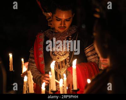 (190414) -- BANGKOK, April 14, 2019 (Xinhua) -- An artist lights up candles for the Nang yai shadow puppet performance at Wat Khanon in Ratchaburi Province, Thailand, April 13, 2019. Nang yai is a form of shadow play found in Thailand and Cambodia. Puppets are made of painted buffalo hide, while the story is narrated by songs, chants and music. (Xinhua/Zhang Keren) THAILAND-RATCHABURI-SHADOW PUPPET PUBLICATIONxNOTxINxCHN Stock Photo