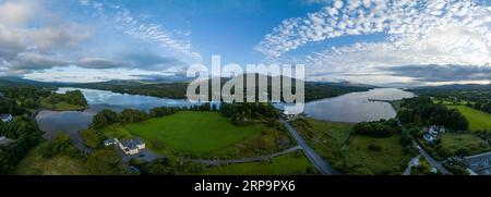 Aerial panorama view of Kenmare Bay at the entrance of the Ring of Kerry in Ireland, Our Lady's Bridge crossing the water, stunning colorful sunset Stock Photo