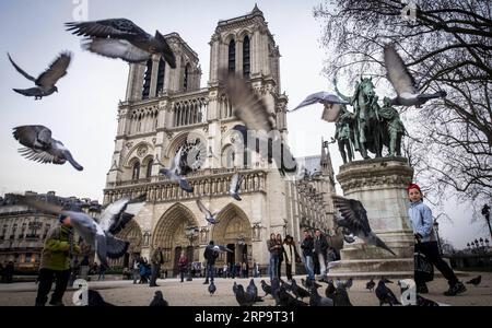 (190416) -- PARIS, April 16, 2019 (Xinhua) -- In this file photo taken on March 13, 2015, tourists visit the Notre Dame Cathedral in Paris, France. The devastating fire at Notre Dame Cathedral in central Paris has been put out after burning for 15 hours, local media reported on April 16, 2019. In early evening on April 15, a fire broke out in the famed cathedral. Online footage showed thick smoke billowing from the top of the cathedral and huge flames between its two bell towers engulfing the spire and the entire roof which both collapsed later. Notre Dame is considered one of the finest examp Stock Photo
