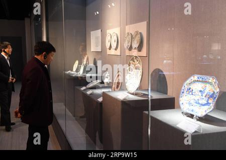 (190417) -- JINGDEZHEN, April 17, 2019 (Xinhua) -- Visitors view porcelains during a ceramics exhibition at China Ceramics Museum in Jingdezhen, east China s Jiangxi Province. Nearly 300 export porcelains, later bought back to China by collectors, were displayed at the ceramic exhibition. Most of the exhibits were made in Jingdezhen, a world famous ceramics capital . (Xinhua/Zhou Mi) CHINA-JINGDEZHEN-PORCELAIN-EXHIBITION(CN) PUBLICATIONxNOTxINxCHN Stock Photo