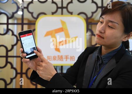 (190419) -- YANGQUAN, April 19, 2019 (Xinhua) -- A staff worker demonstrates the platform of Sui Shou Pai , an app that allows people to express their concerns by submiting pictures, at the Yangquan radio and television station in Yangquan, north China s Shanxi Province, April 15, 2019. Yangquan has been transforming from a coal-dependent city to a city applying new technologies of Big Data and information services to various aspects of social life and developments. From harboring Baidu s cloud computing center, to taking advantages of various apps and platforms to collect citizen s concerns, Stock Photo