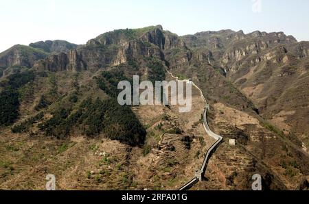 (190420) -- TIANJIN, April 20, 2019 (Xinhua) -- Aerial photo taken on April 19, 2019 shows the western end of the Huangyaguan Great Wall in the northern suburb of Tianjin, north China. The Huangyaguan Great Wall was built more than 14 centuries ago for border defense purpose. The structure winds its way for about 3,000 meters along the mountain areas of today s Jizhou District on the outskirts of Tianjin. (Xinhua/Yue Yuewei) CHINA-TIANJIN-HUANGYAGUAN GREAT WALL (CN) PUBLICATIONxNOTxINxCHN Stock Photo