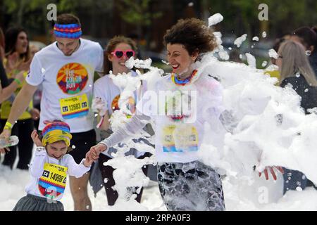 (190421) -- BUCHAREST, April 21, 2019 -- People participate in a color run event in Bucharest, Romania, on April 20, 2019. (SP)ROMANIA-BUCHAREST-COLOR RUN (Xinhua/CristianxCristel) PUBLICATIONxNOTxINxCHN Stock Photo