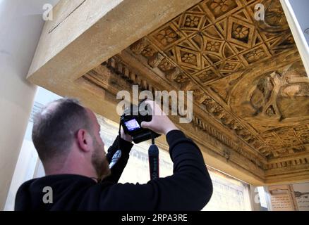 (190424) -- SYRIA, April 24, 2019 -- A man takes photos of the 3D-printed ceiling of the Bel Temple in the Damascus National Museum in Damascus, Syria, on April 23, 2019. A 3D-printed ceiling of a worship area of the Bel Temple of Palmyra was showcased in the Damascus National Museum on Tuesday. Italian artists replicated the part of the ceiling that was produced as a gift to the national museum. The original part of the ceiling was destroyed along with the entire Bel Temple by the Islamic State (IS) group during its invasion of the ancient oasis city of Palmyra in 2014. ) SYRIA-DAMASCUS-ARCHE Stock Photo