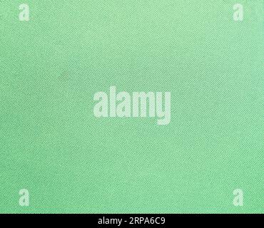 Close-up texture of light Green fabric or cloth in light  Green color. Fabric texture of natural cotton or linen textile material. Green canvas backgr Stock Photo