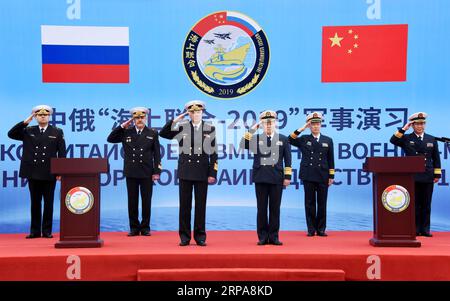 (190429) -- QINGDAO, April 29, 2019 (Xinhua) -- Representatives of both China and Russia salute at the welcome ceremony for Russian navy vessels in Qingdao, east China s Shandong Province, April 29, 2019. Russian naval vessels arrived in Qingdao on Monday to participate in the Sino-Russian Joint Sea-2019 exercise. The exercise will focus on joint sea defense, which aims to consolidate and develop the China-Russia comprehensive strategic partnership of coordination, deepen pragmatic naval cooperation, and improve their capabilities to jointly respond to security threats at sea. Two submarines, Stock Photo