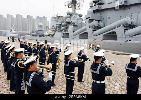 (190429) -- QINGDAO, April 29, 2019 (Xinhua) -- The military band of the Chinese People s Liberation Army (PLA) Navy plays music to welcome Russian cruiser Varyag at Dagang port of Qingdao, east China s Shandong Province, April 29, 2019. Russian naval vessels arrived in Qingdao on Monday to participate in the Sino-Russian Joint Sea-2019 exercise. The exercise will focus on joint sea defense, which aims to consolidate and develop the China-Russia comprehensive strategic partnership of coordination, deepen pragmatic naval cooperation, and improve their capabilities to jointly respond to security Stock Photo