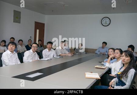 (190504) -- WUHAN, May 4, 2019 (Xinhua) -- Photo taken on April 19, 2019 shows Zhou Xin and members of his group at a meeting at Wuhan Institute of Physics and Mathematics of Chinese Academy of Sciences in Wuhan, capital of central China s Hubei Province. Professor Zhou Xin is the deputy director of Wuhan Institute of Physics and Mathematics of Chinese Academy of Sciences, State Key Laboratory of Magnetic Resonance and Atomic and Molecular Physics, and National Center for Magnetic Resonance in Wuhan. He is interested in ultrasensitive magnetic resonance imaging (MRI) instruments, techniques an Stock Photo
