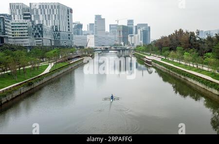 (190508) -- SHENZHEN, May 8, 2019 (Xinhua) -- Aerial photo taken on April 17, 2019 shows Xiao Guoxun taking part in training under the instruction of his coach on the Dasha river in Shenzhen, south China s Guangdong Province. 33-year-old Xiao Guoxun, an entrepreneur who runs business on healthy food in Shenzhen, insisted in trying a sport after every birthday since his 30. He tried hiking in 2016, running marathon in 2017 and rowing in 2018. He have joined in a rowing club and takes part in rowing training every Tuesday and Thursday. He said rowing requires every member to make concerted effor Stock Photo