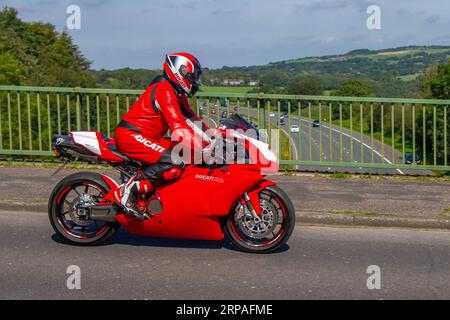 2005 Red Ducati 749 S V Twin Motorcycle Supersports Petrol 748 cc, 'big twin' power ; travelling at speed on the M6 motorway in Greater Manchester, UK Stock Photo