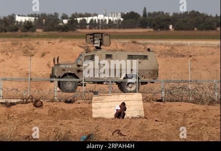 (190510) -- GAZA, May 10, 2019 -- A Palestinian boy takes cover during clashes with Israeli troops on the Gaza-Israel border, east of southern Gaza Strip city of Khan Younis, May 10, 2019. At least one Palestinian demonstrator was killed and 30 others wounded on Friday during their clashes with Israeli soldiers stationed on the border between the eastern Gaza Strip and Israel. ) MIDEAST-GAZA-CLASHES YasserxQudih PUBLICATIONxNOTxINxCHN Stock Photo