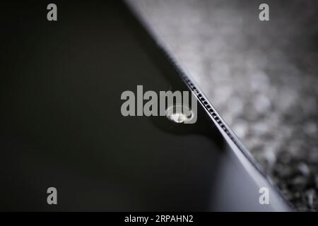 mobile camera lens on black background, macro view. the front camera of the smartphone. Stock Photo