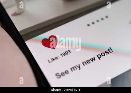 Close-up Of Man Using Social Network On Digital Tablet. All the graphics on the screen are made up. Stock Photo