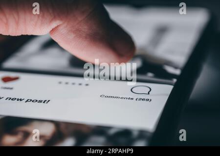 Young man using smart phone, Social media concept. All the graphics on the screen are made up. Stock Photo