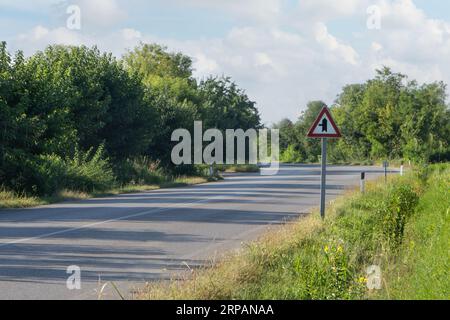 Intersection road sign with right of way on a country road Stock Photo