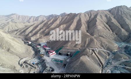 (190516) -- RUOQIANG, May 16, 2019 (Xinhua) -- Photo taken on May 15, 2019 shows the exit of the tunnel though Altun Mountains in Ruoqiang County, northwest China s Xinjiang Uygur Autonomous Region. The 13.195-kilometer-long tunnel through Altun Mountains is the longest tunnel of the Golmud-Korla railway line. The railway line, connecting Golmud in Qinghai and Korla in Xinjiang, is the third rail artery linking Xinjiang with neighboring provinces. The line will cut the traffic time between Golmud and Korla from 26 hours to 12 hours. (Xinhua/Ding Lei) CHINA-XINJIANG-RAILWAY-TUNNEL-CONSTRUCTION Stock Photo