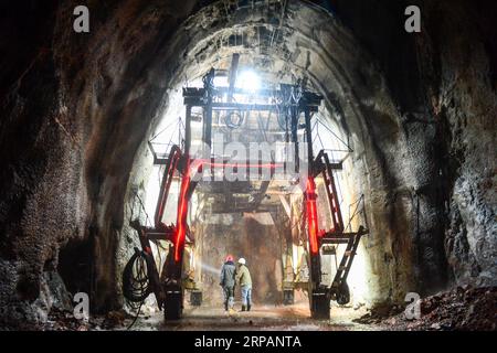 (190516) -- RUOQIANG, May 16, 2019 (Xinhua) -- Technicians check the status of the tunnel in Ruoqiang County, northwest China s Xinjiang Uygur Autonomous Region, May 15, 2019. The 13.195-kilometer-long tunnel through Altun Mountains is the longest tunnel of the Golmud-Korla railway line. The railway line, connecting Golmud in Qinghai and Korla in Xinjiang, is the third rail artery linking Xinjiang with neighboring provinces. The line will cut the traffic time between Golmud and Korla from 26 hours to 12 hours. (Xinhua/Ding Lei) CHINA-XINJIANG-RAILWAY-TUNNEL-CONSTRUCTION (CN) PUBLICATIONxNOTxIN Stock Photo