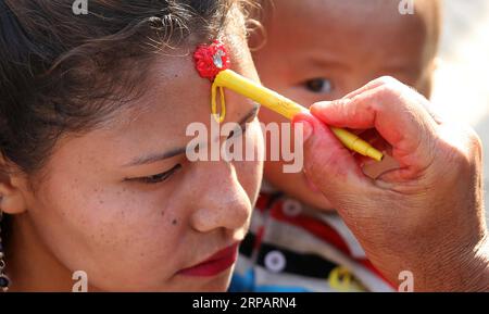 (190518) -- KATHMANDU, May 18, 2019 -- A woman puts Tika as blessings during the celebration of Buddha Jayanti Festival at Swayambhunath in Kathmandu, capital of Nepal, on May 18, 2019. The Buddha Jayanti festival is celebrated as a holy day by Buddhists in many Asian countries to mark the birth, enlightenment and Nirvana of Gautam Buddha. ) NEPAL-KATHMANDU-BUDDHA JAYANTI FESTIVAL SunilxSharma PUBLICATIONxNOTxINxCHN Stock Photo